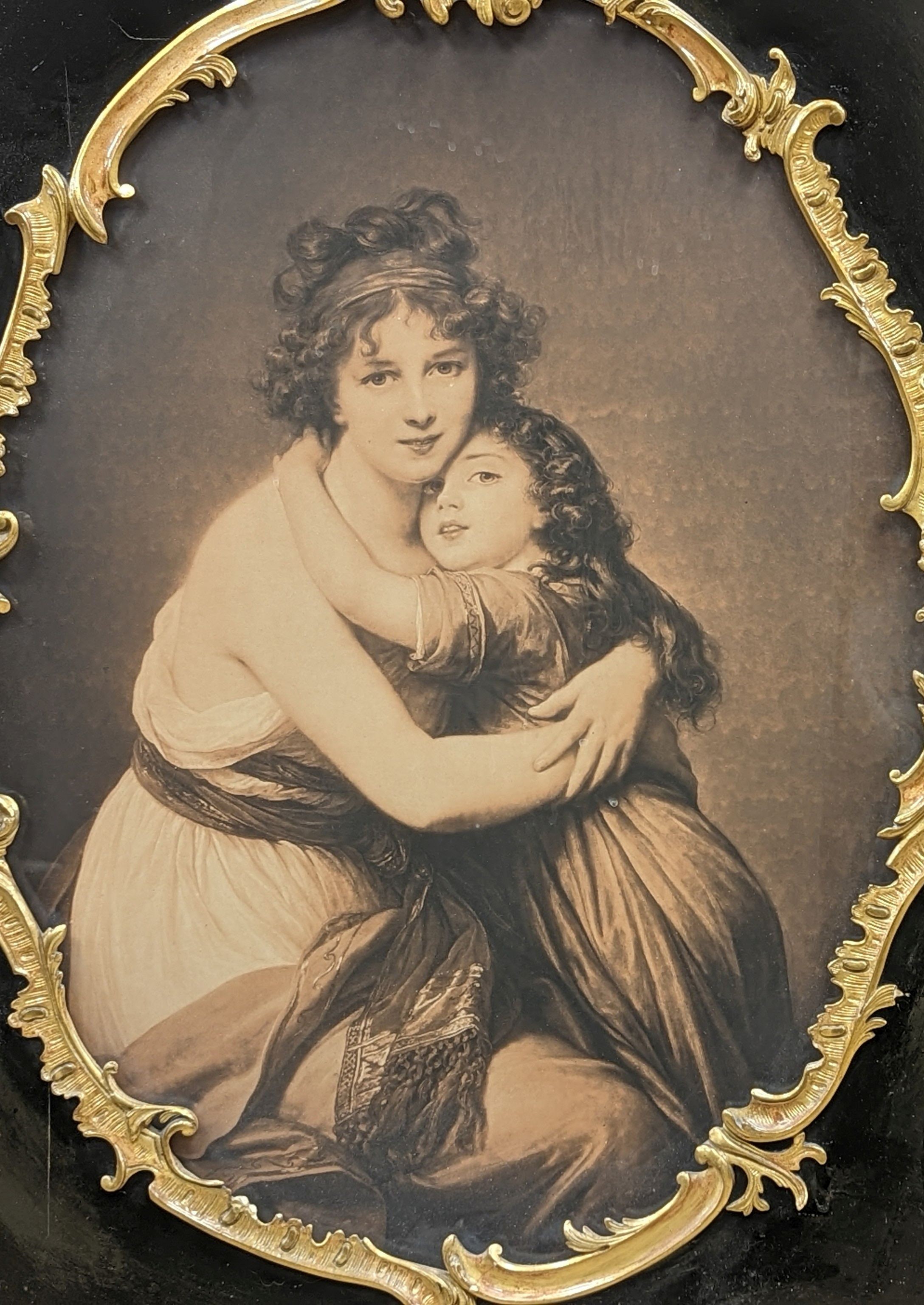 A sepia print of a mother and child within parcel gilt ebonised frame, overall 103 x 75cm